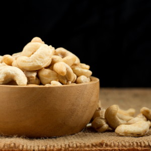 Cashew nuts on wooden cup.